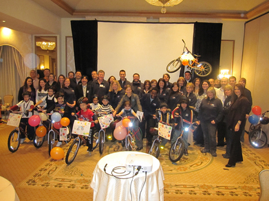 Sales Team Builds Bikes For Kids.  T-Shirt Photo